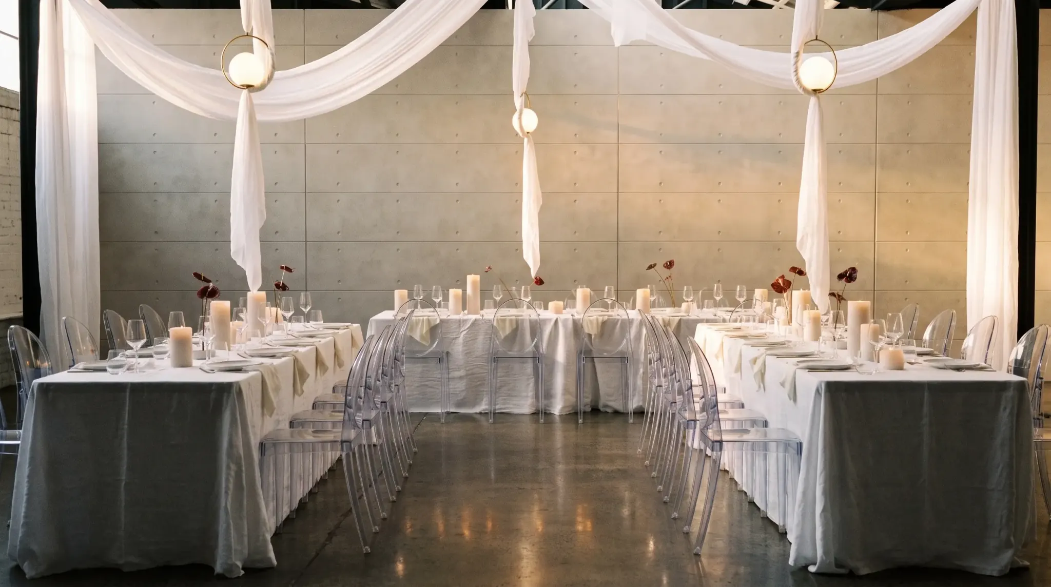 Walking between two long banquet tables, ghost chairs either side